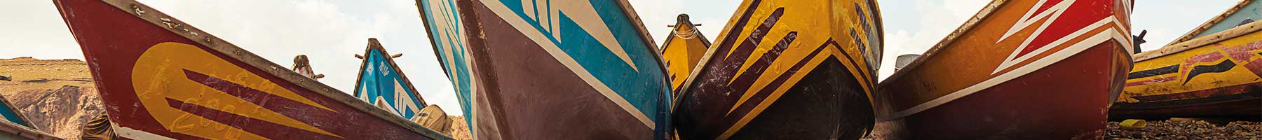 colorful boats on a shingle beach