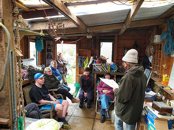 group of people chatting in a garden shed