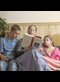 a mother reading a story to two children
