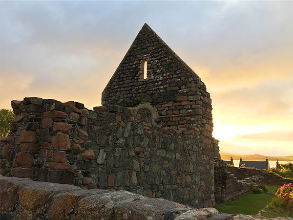 ruins of an old church backlit by the sunrise