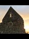 ruins of an old church backlit by the sunrise