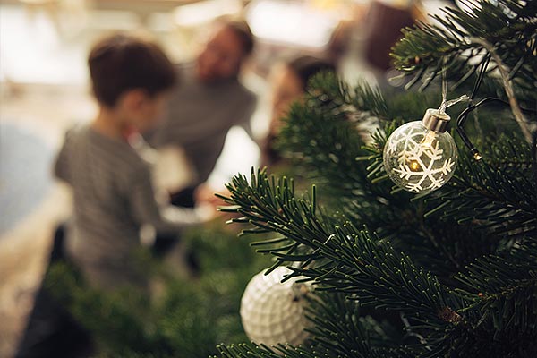 photo of a child with a Christmas tree in the foreground