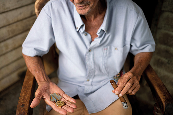 a man holding a medal in his hand