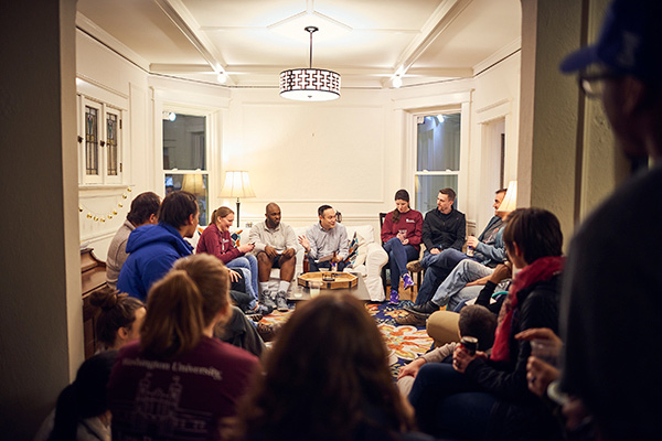 people sitting in a circle in a room