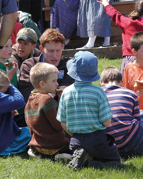 children eating food on the grass