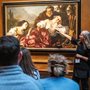 people looking at a painting