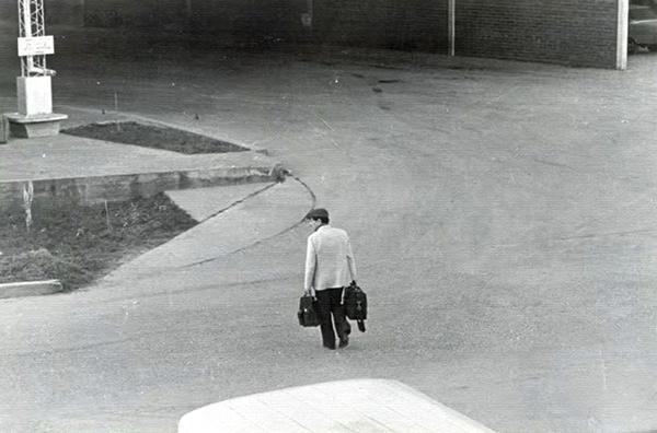 man with bags on a road