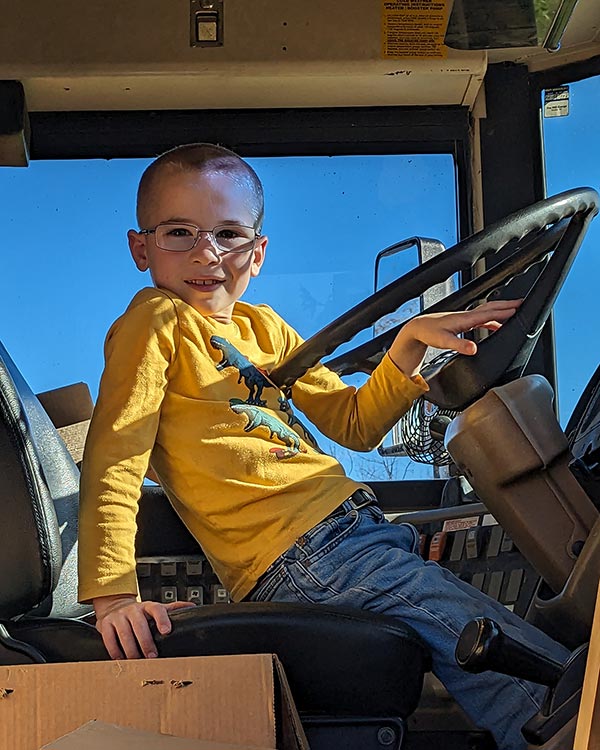 kid in a bus driver's seat