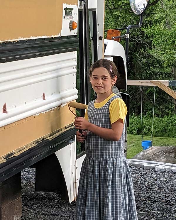 girl painting a bus