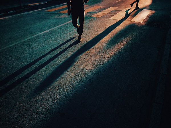 people's shadows on a road