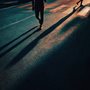 people's shadows on a road