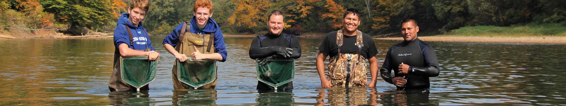 students standing in a river