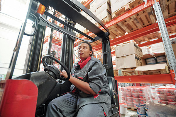 woman operating a forklift in a warehouse