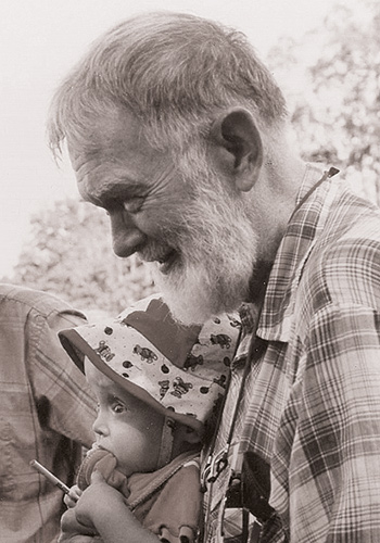 an elderly man holding a baby