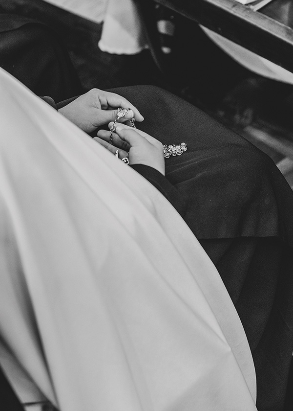 hands in a lap doing the rosary